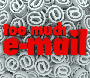 The words Too Much E-Mail on a background of email at symbols an