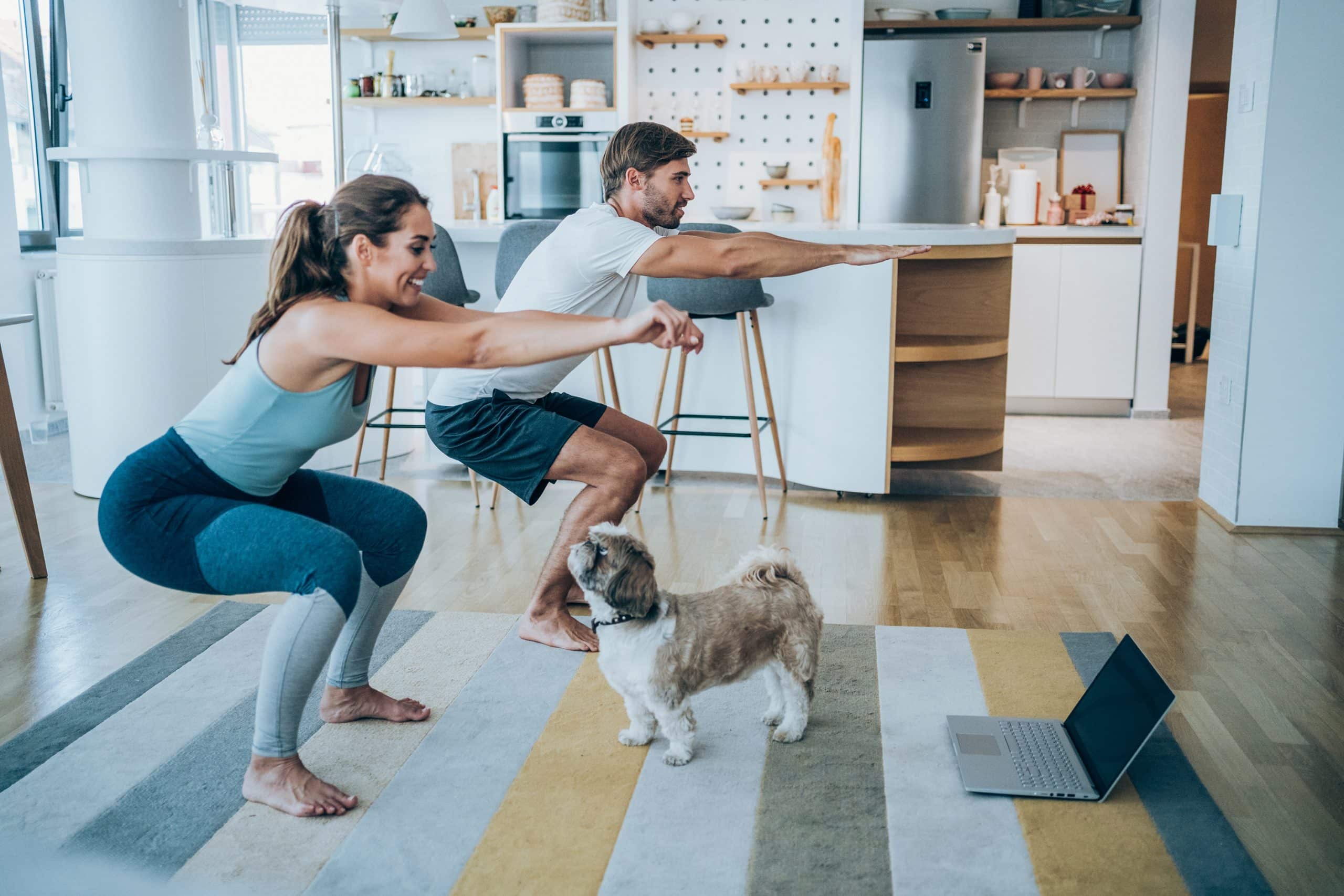 Couple exercising together at home using internet service.