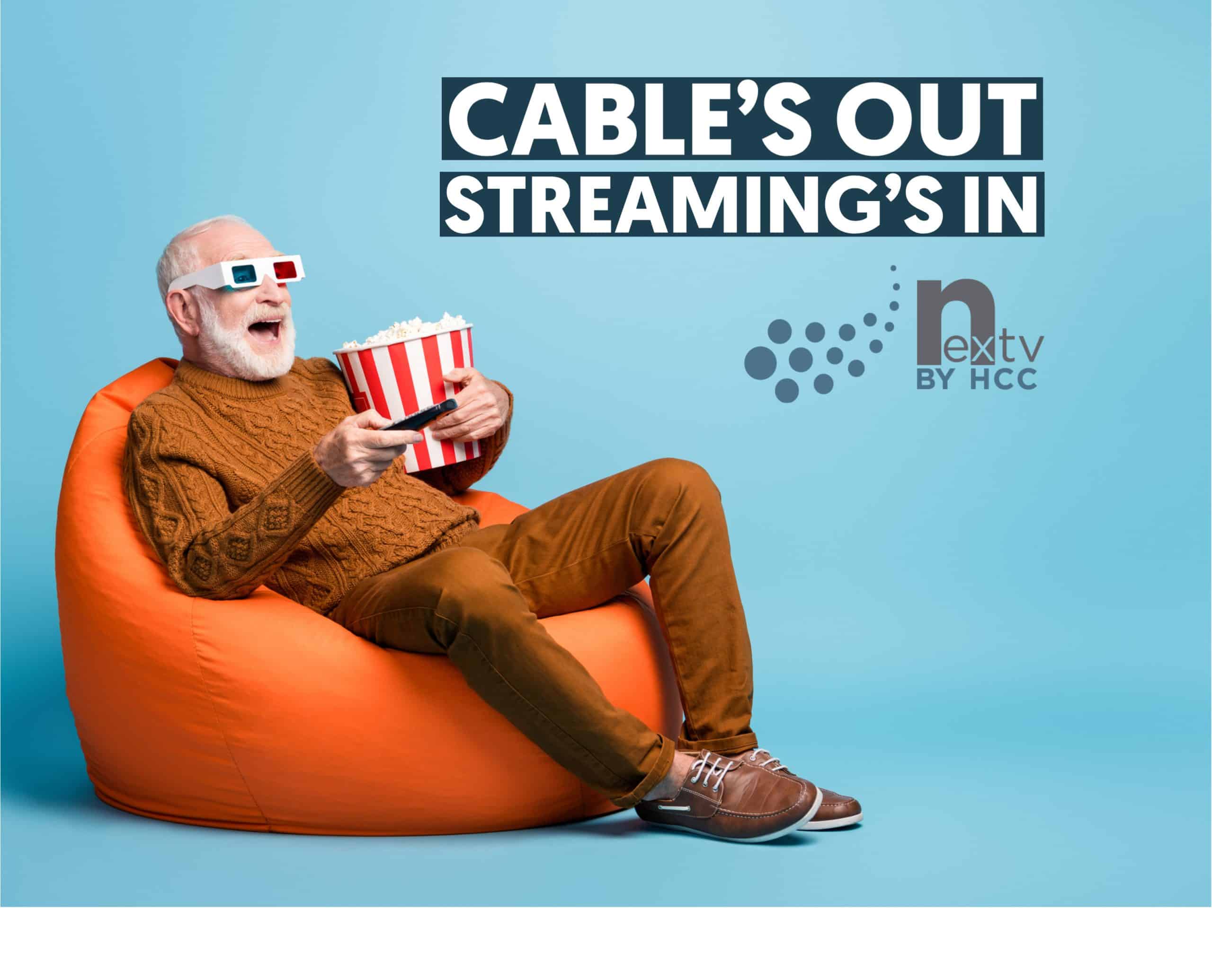 Image of an excited senior citizen wearing 3d glasses sitting on a bean bag eating popcorn.