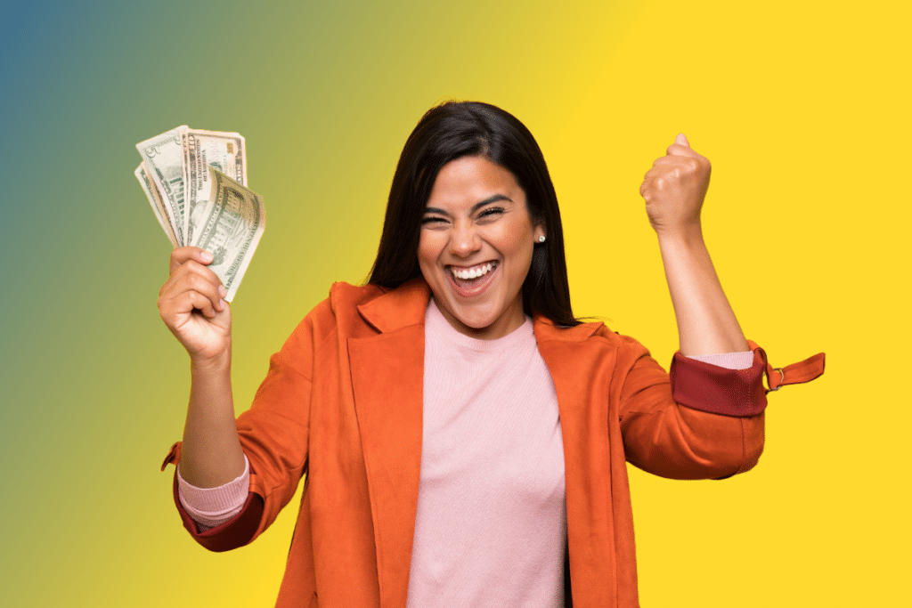 Woman excitedly holding cash in one hand.